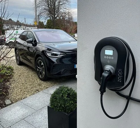 A home EV charger fitted to the wall of an Irish house with a car on the driveway