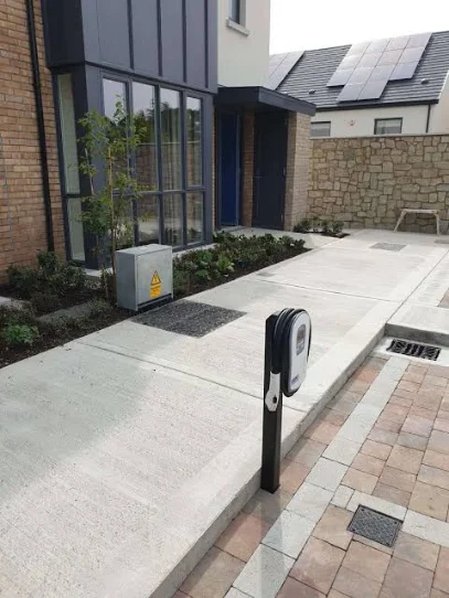 EV charger fitted to a house wall with a car plugged in